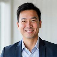 Professional headshot of David Chen, a friendly man with a confident smile, ideal for a fitness specialist profile.